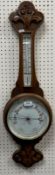 A late Victorian carved oak cased aneroid barometer with mercury thermometer,