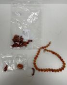 A carnelian bead necklace, 46 cm long, another carnelian bead necklace in need of re-stringing,