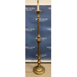 A circa 1900 carved giltwood and gesso standard lamp in the Classical style with flower head and