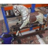 An early 20th Century dapple grey painted rocking horse on twin pedestal base,