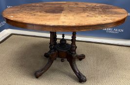 A Victorian walnut and marquetry inlaid oval loo table on cluster column supports to foliate carved
