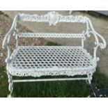 A late Victorian cast iron white painted two seat garden bench in the Coalbrookdale manner with bar