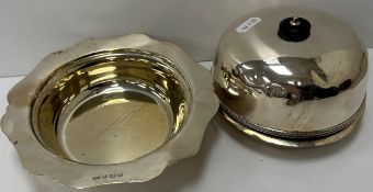 A silver muffin dish with ebonised handle and of typical form with gadrooned decoration to the base