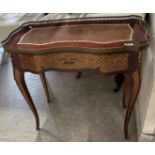 A 20th Century mahogany and marquetry inlaid writing table in the Louis XVI taste,