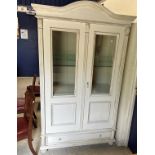 A modern painted two door glazed cabinet in the 18th Century French taste with moulded cornice over