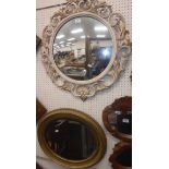 A Victorian oval gilt framed wall mirror with bevel edge plate 56 cm wide x 52 cm high and a