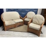 A modern cane work conservatory suite of two seat settee and pair of armchairs, settee 130 cm wide,
