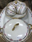 A Limoges porcelain dinner service comprising one large serving platter, two small serving dishes,