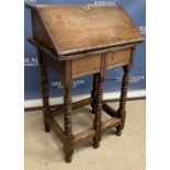 A 20th Century oak writing table in the 17th Century manner as a slope front Bible box on stand,