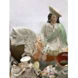 A collection of Staffordshire pottery flat back figures and spill vases including figure of