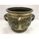 A Chinese brass jardiniere with relief panel decoration depicting dragon, turtle,