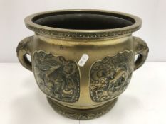 A Chinese brass jardiniere with relief panel decoration depicting dragon, turtle,