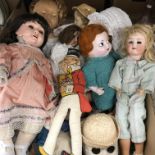 A box containing a collection of various dolls and toys including a Heubach Köppelsdorf biscuit