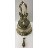 A 19th Century Sino Tibetan bronze bell with temple lion decorated hanging loop and ribbed