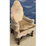 A 20th Century Flemish style high back scroll arm chair on turned and block legs united by shaped