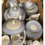 A modern Doulton pale blue and gilt banded dinner/tea service designed by Bruce Oldfield (circa