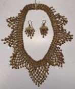 A Continental filigree work necklace with flower head medallion ring and ball decoration, 42.