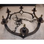 A 20th Century wrought iron eight light electrolier in the Arts & Crafts manner,