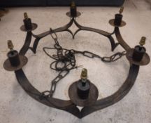 A 20th Century wrought iron eight light electrolier in the Arts & Crafts manner,