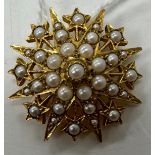 A 9 carat gold pearl set star burst brooch 3 cm wide, 8.