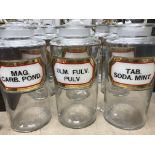 A set of nine cylindrical glass pharmacy jars each with printed labels inscribed "Mag.carb.pond.