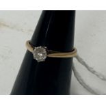 An 18 carat gold and platinum mounted claw set solitaire diamond ring, approx 0.