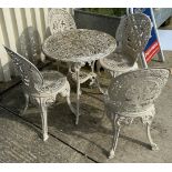 A white painted metal set of four chairs in the Victorian style,