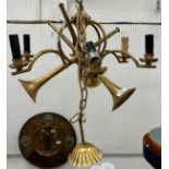A modern patinated gold painted six branch electrolier or ceiling light as three entwined trumpets
