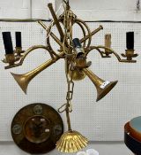 A modern patinated gold painted six branch electrolier or ceiling light as three entwined trumpets