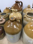 A collection of eleven various stoneware jars and flagons including one by Powell of Bristol,