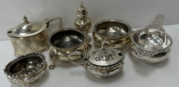 A collection of silver wares to include a pair of Victorian cauldron salts raised on lion's paw