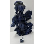 A Chinese carved lapis lazuli figure of a woman in flowing robes holding a palm leaf fan 20 cm high