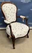 A Victorian mahogany framed spoon back salon armchair on cabriole legs to castors 62 cm wide x 98