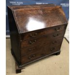 A George III mahogany bureau, the plain top over a plum pudding fall,