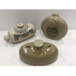A collection of four stoneware foot warmers including two "Doulton's Improved" foot warmers,
