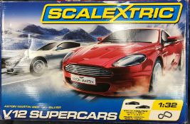 A collection of toys to include boxed Scalextric V12 Supercars set, Astin Martin red versus silver,