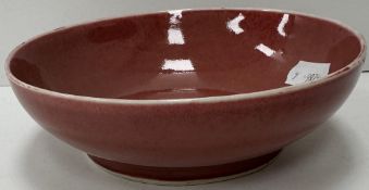 A Chinese pink / rose glazed bowl with white rim,