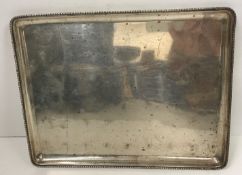 A rectangular silver tray with beaded edge (marks rubbed), 27.2 cm long x 21.2 cm wide, 13.
