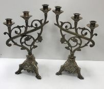 A collection of various metal and treen ware including a pair of plated three branch candelabra in