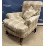 A modern faun check upholstered scroll arm chair on turned front legs to brass caps and castors in