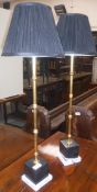 A pair of modern Coach House table lamps with gilt bamboo style columns raised on square socle type