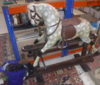 An early 20th Century dapple grey painted rocking horse on twin pedestal base,