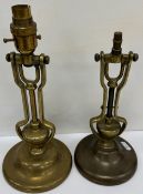 Two brass gimbal lamps of typical form with circular foot and wall mounting hook to the base,