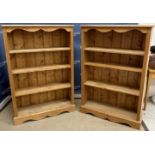 A pair of modern pine open bookcases with plain tops over three adjustable shelves on a bracket