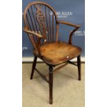 A 19th Century Thames Valley wheel and stick back elbow chair on turned legs united by H stretcher,