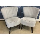 A pair of modern grey upholstered occasional chairs with shell style back,