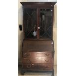 An early 20th Century mahogany bureau bookcase, the upper section with two astragal glazed doors,