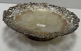 A George V silver tazza with cast and pierced grape and vine border on a plain circular foot (by