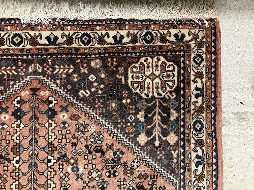 A Persian rug, the central panel set with all-over floral motifs on a dark blue ground, - Image 49 of 66