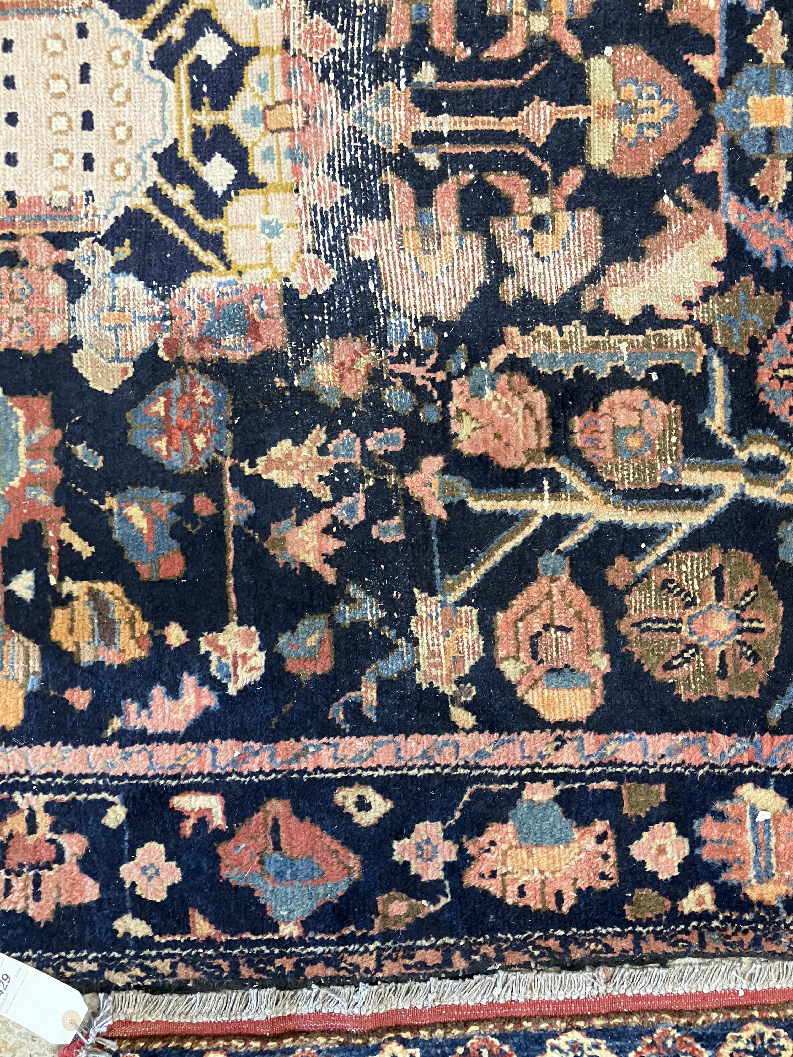 A Persian rug, the central panel set with all-over floral motifs on a dark blue ground, - Image 24 of 66